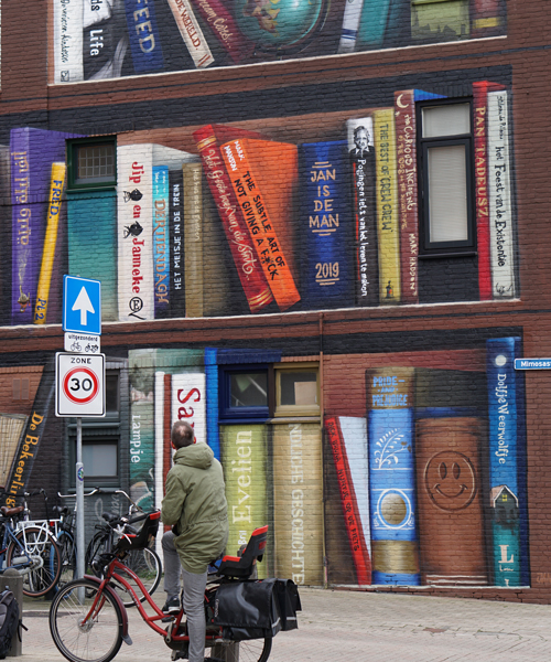 curated by the neighborhood, this book shelf illusion features 8 languages and cultures