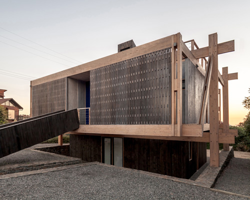 a detached latticed structure wraps around tacna house by par arquitectos