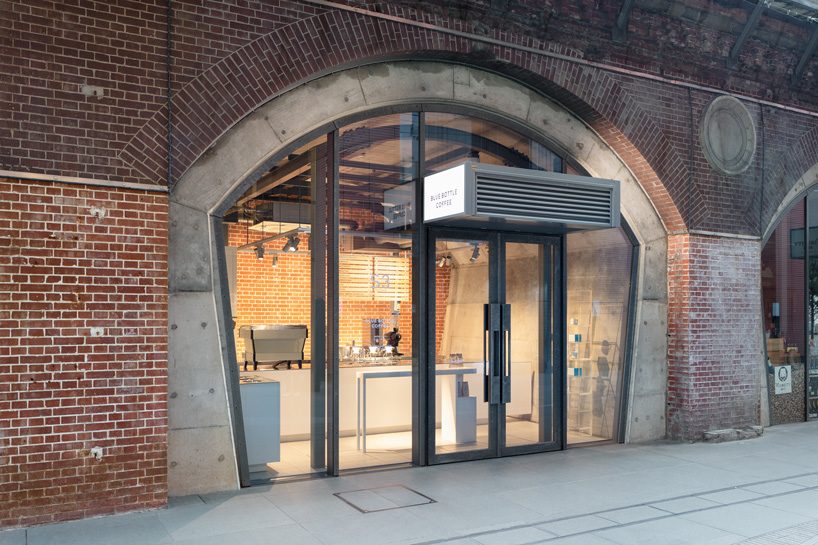 schemata architects tucks eleventh blue bottle cafe under 100-year-old bridge in tokyo