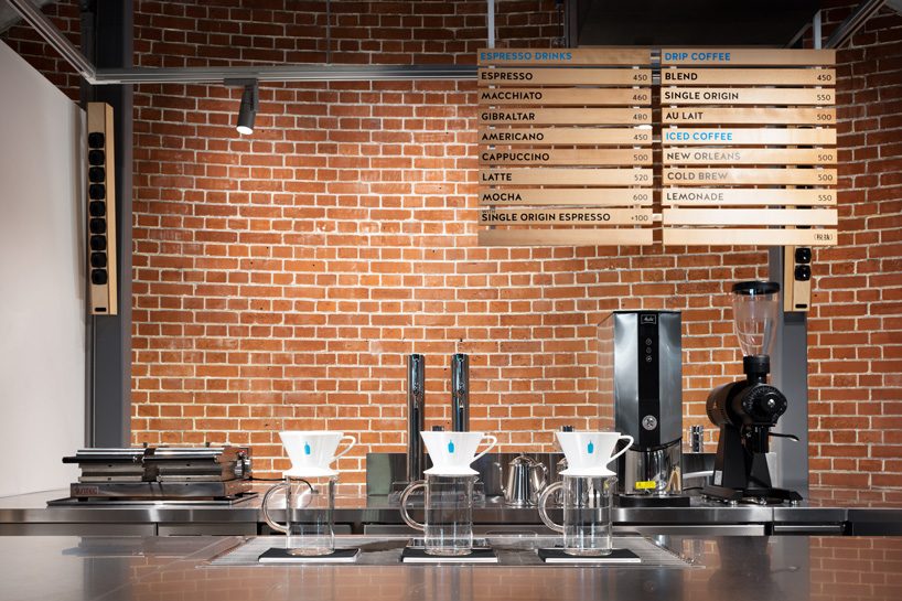 schemata architects tucks eleventh blue bottle cafe under 100-year-old bridge in tokyo