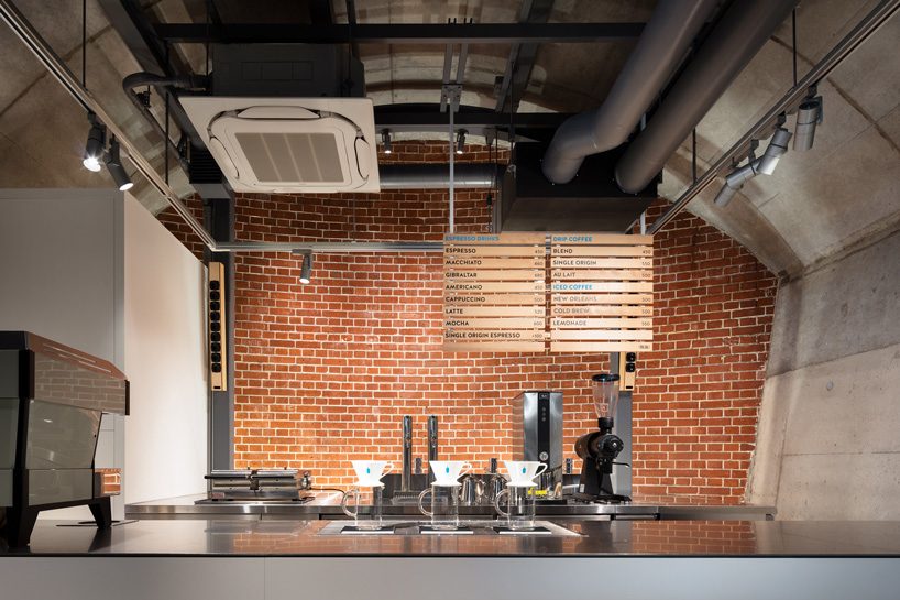 schemata architects tucks eleventh blue bottle cafe under 100-year-old bridge in tokyo