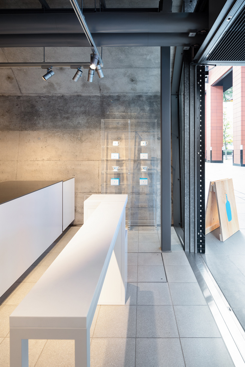 schemata architects tucks eleventh blue bottle cafe under 100-year-old bridge in tokyo