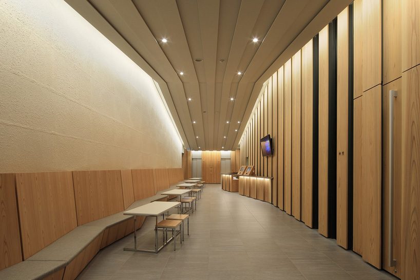 kengo kuma tops buddhist temple in tokyo with half-cylinder aluminum tiles