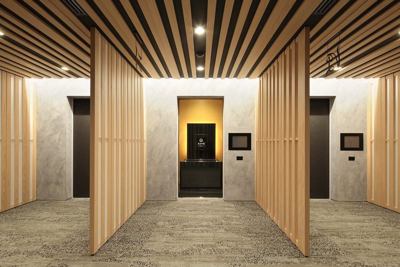 kengo kuma tops buddhist temple in tokyo with half-cylinder aluminum tiles