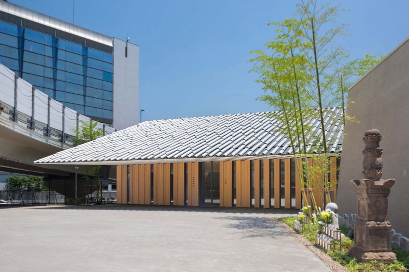 kengo kuma tops buddhist temple in tokyo with half-cylinder aluminum tiles