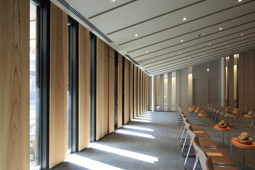kengo kuma tops buddhist temple in tokyo with half-cylinder aluminum tiles