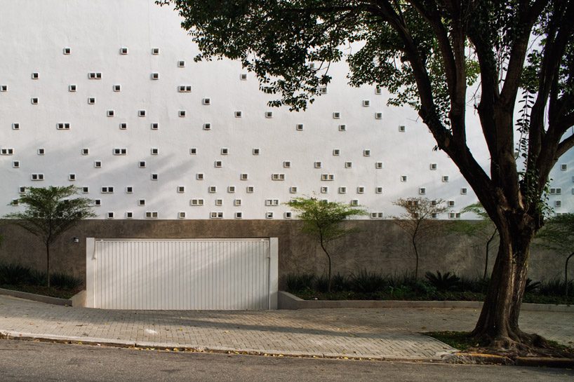 carolina penna architects designs a training center around existing trees in brazil