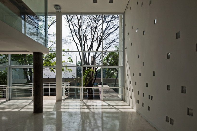 carolina penna architects designs a training center around existing trees in brazil