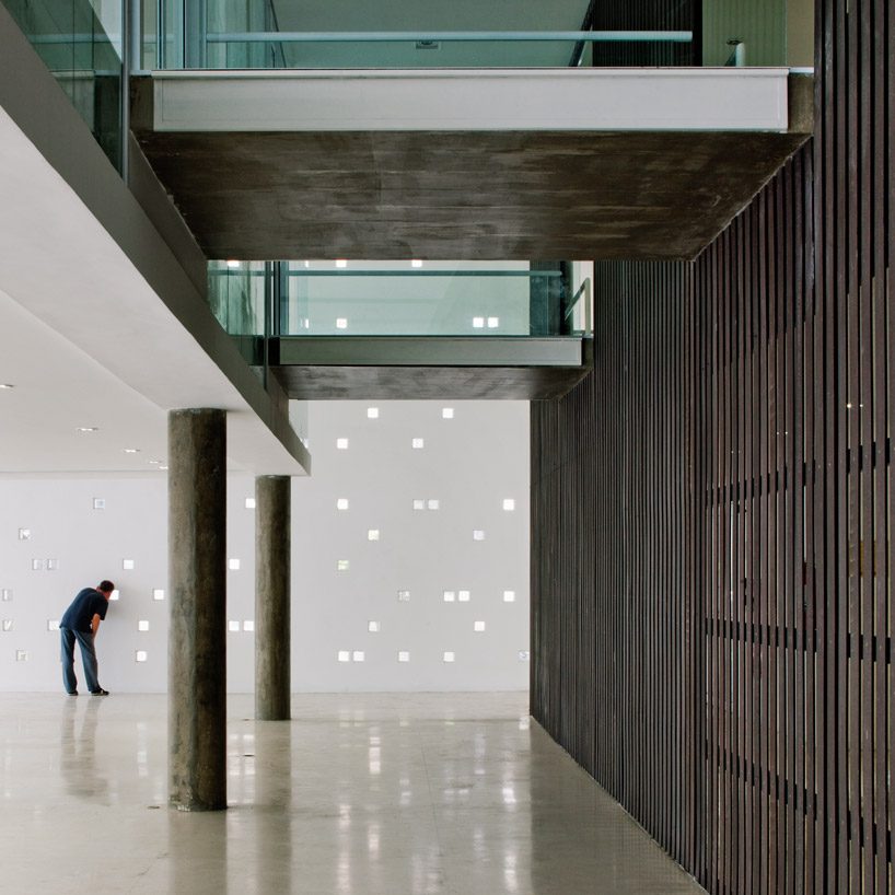 carolina penna architects designs a training center around existing trees in brazil