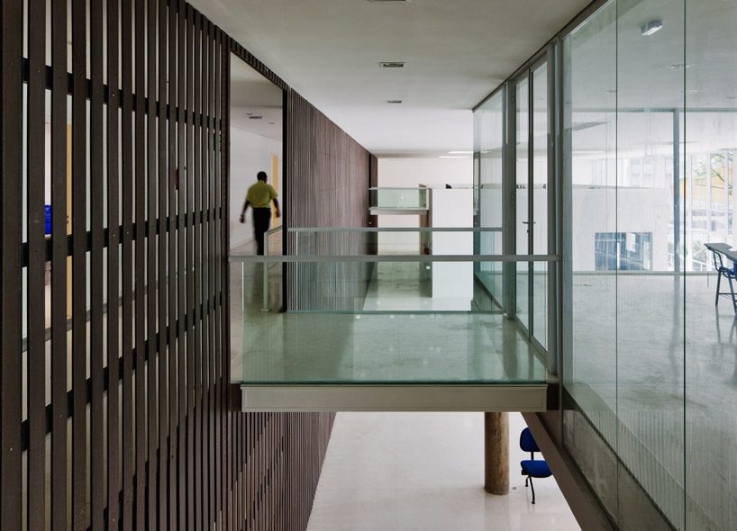 carolina penna architects designs a training center around existing trees in brazil