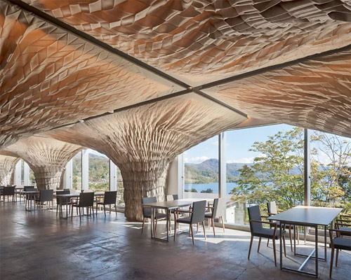 kengo kuma transforms japanese nursing home into the WE hotel toya using fabric and wood