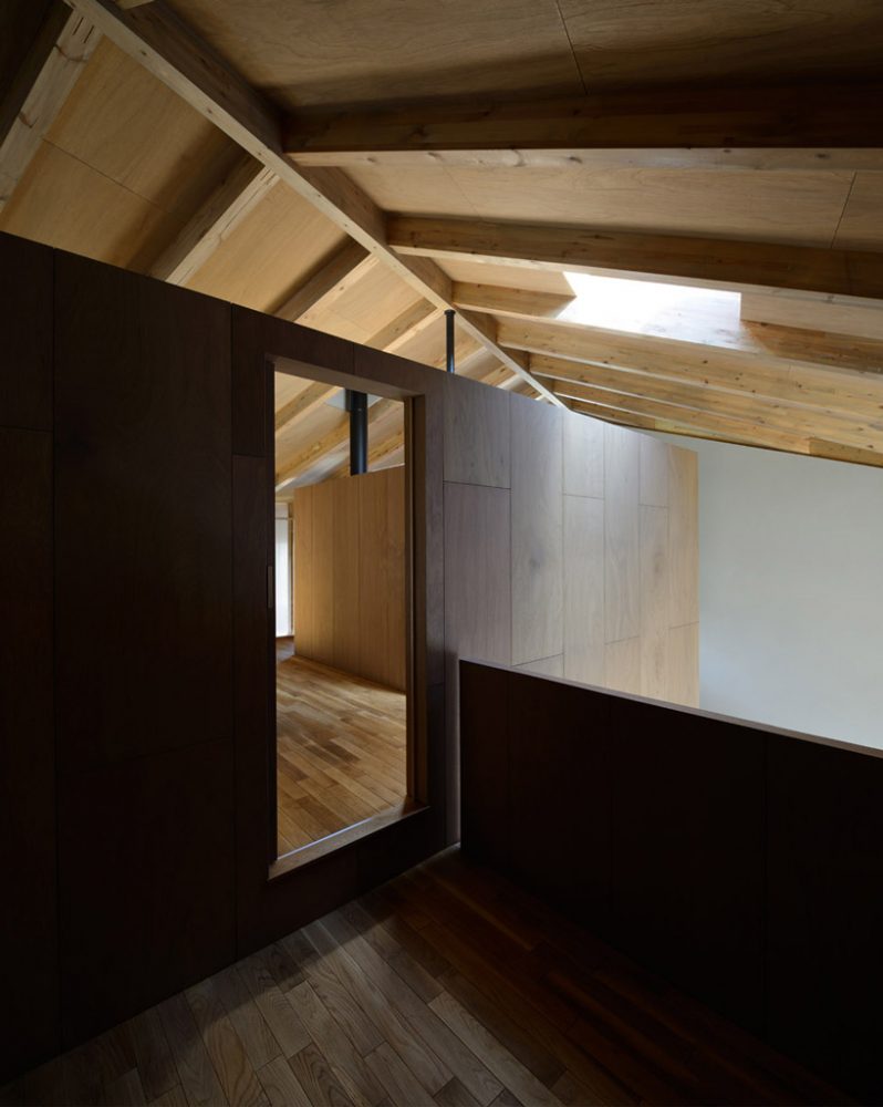 hiroshi horio architects stacks two wooden boxes for family house in japan