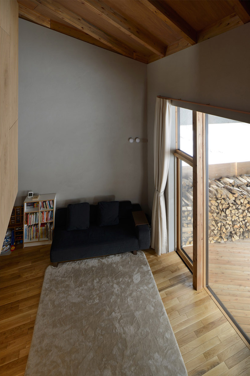 hiroshi horio architects stacks two wooden boxes for family house in japan