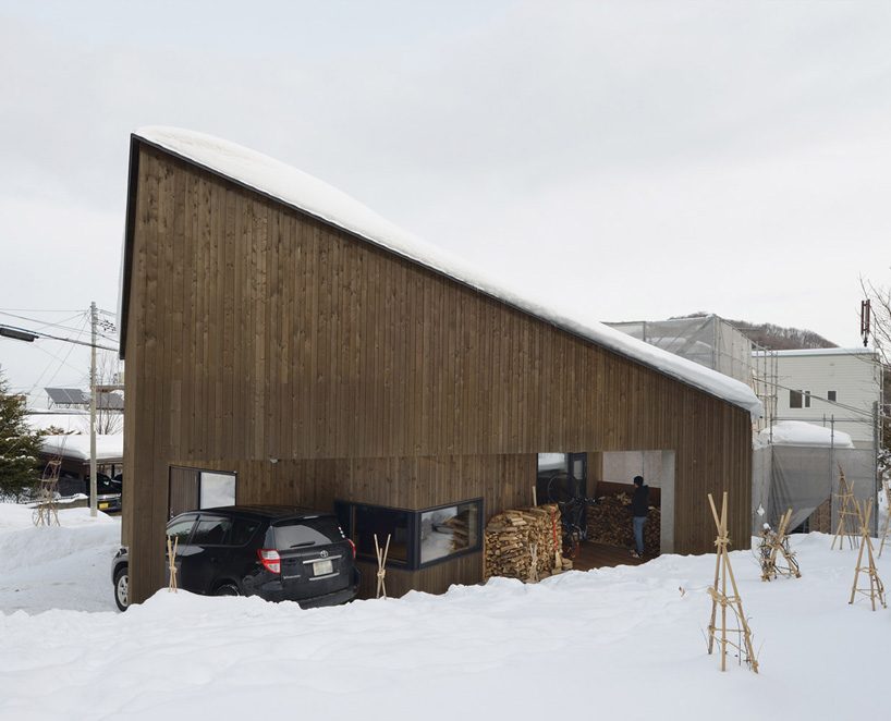 hiroshi horio architects stacks two wooden boxes for family house in japan
