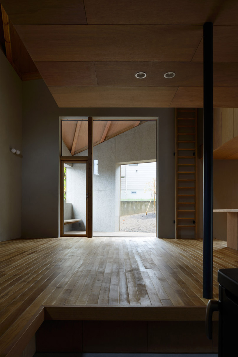 hiroshi horio architects stacks two wooden boxes for family house in japan