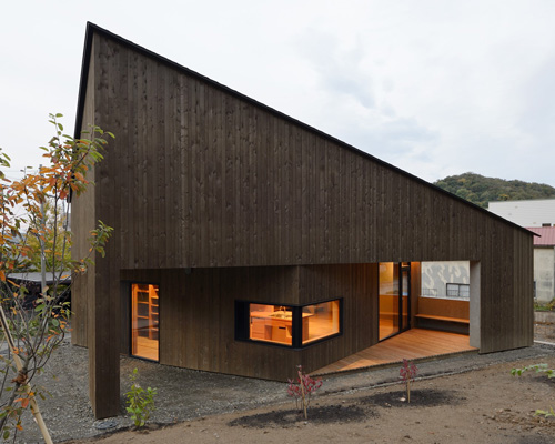 hiroshi horio architects stacks two wooden boxes for family house in japan