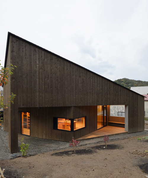 hiroshi horio architects stacks two wooden boxes for family house in japan