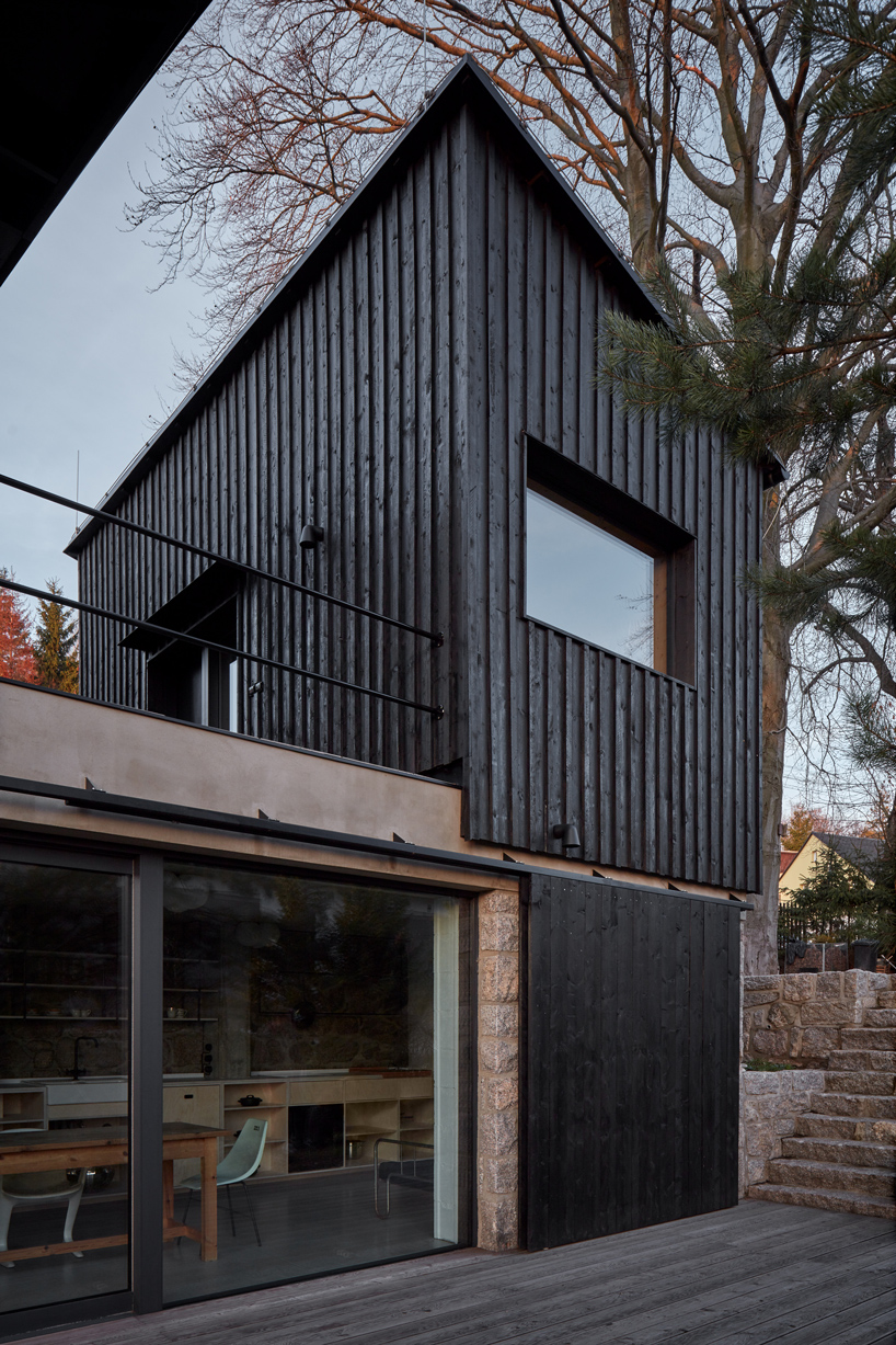 mjolk house behind wall