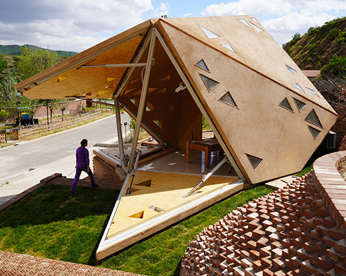 this village hut in china opens and closes in response to the region's weather