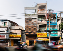 tropical space constructs vietnamese showroom with clay brick + metal frame system