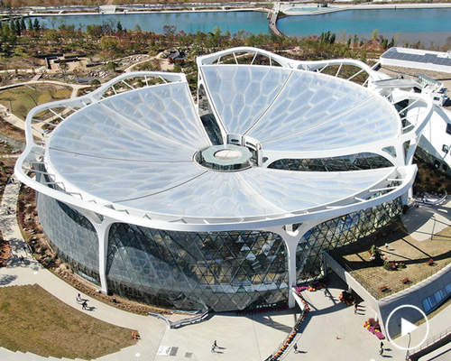 seoul botanic park incorporates a flower-shaped roof and triangular glass façade