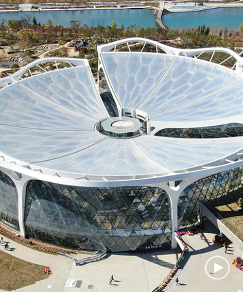 seoul botanic park incorporates a flower-shaped roof and triangular glass façade