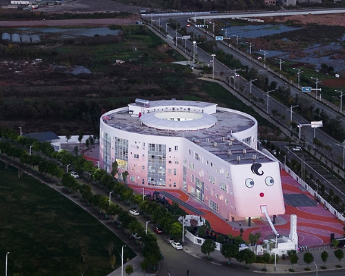 dika kindergarten design center shapes children school into a pink lollipop in china