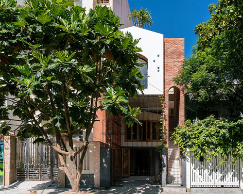 IZ architects completes vietnamese house with front courtyard enclosed by steel grid