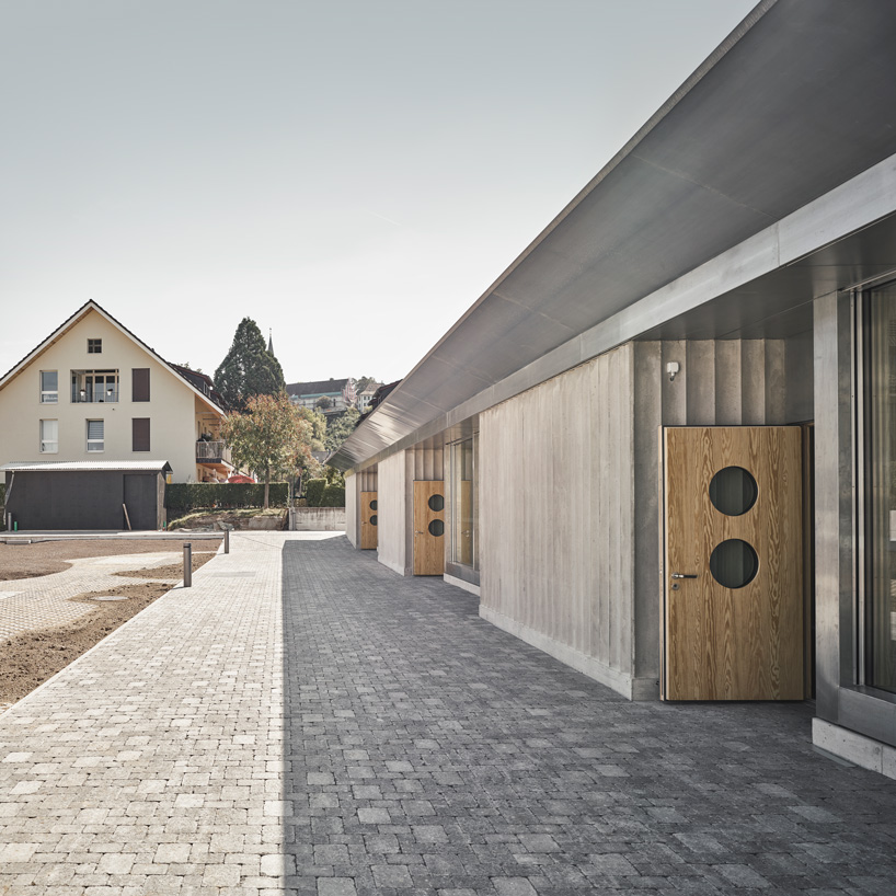 estrada reichen + malte k combine kindergarten with an underground car park in switzerland