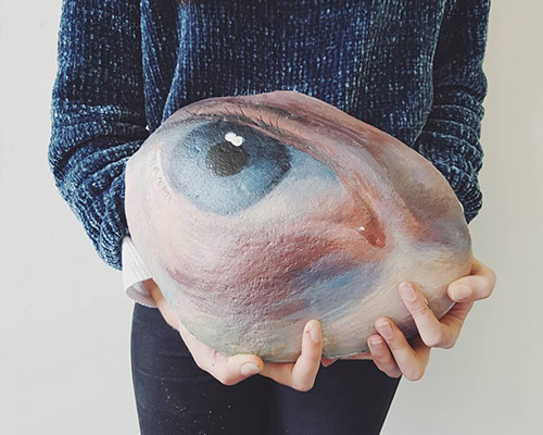 artist paints eyes on stones and then returns them to the place where she found them