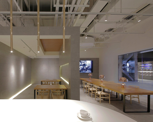 jun murata uses exposed concrete and brass accents for shanghai's café la loop 86