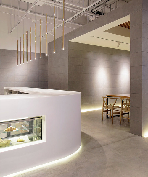 jun murata uses exposed concrete and brass accents for shanghai's café la loop 86