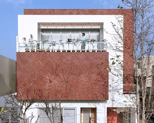manoj patel reuses clay tiles in zig-zagging facade for residence in india