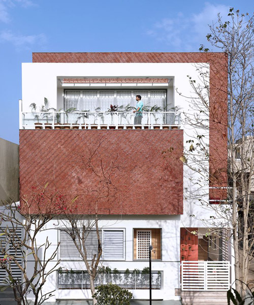 manoj patel reuses clay tiles in zig-zagging facade for residence in india