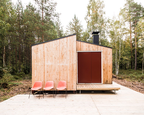 politaire erects wooden cabin in finnish forest with locally-sourced materials