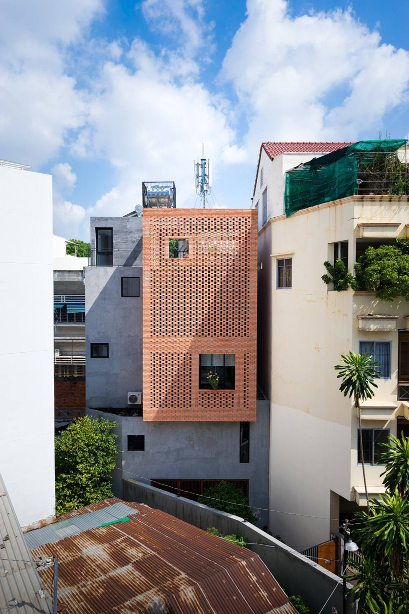 tropical space combines perforated clay brick + concrete for NDC house ...