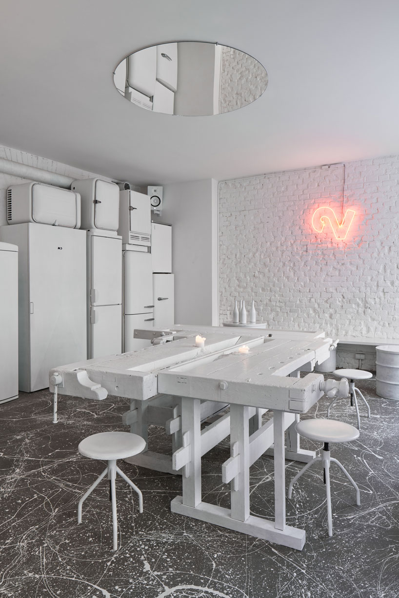 painted entirely white, this prague wine bar recalls a vintage artist studio