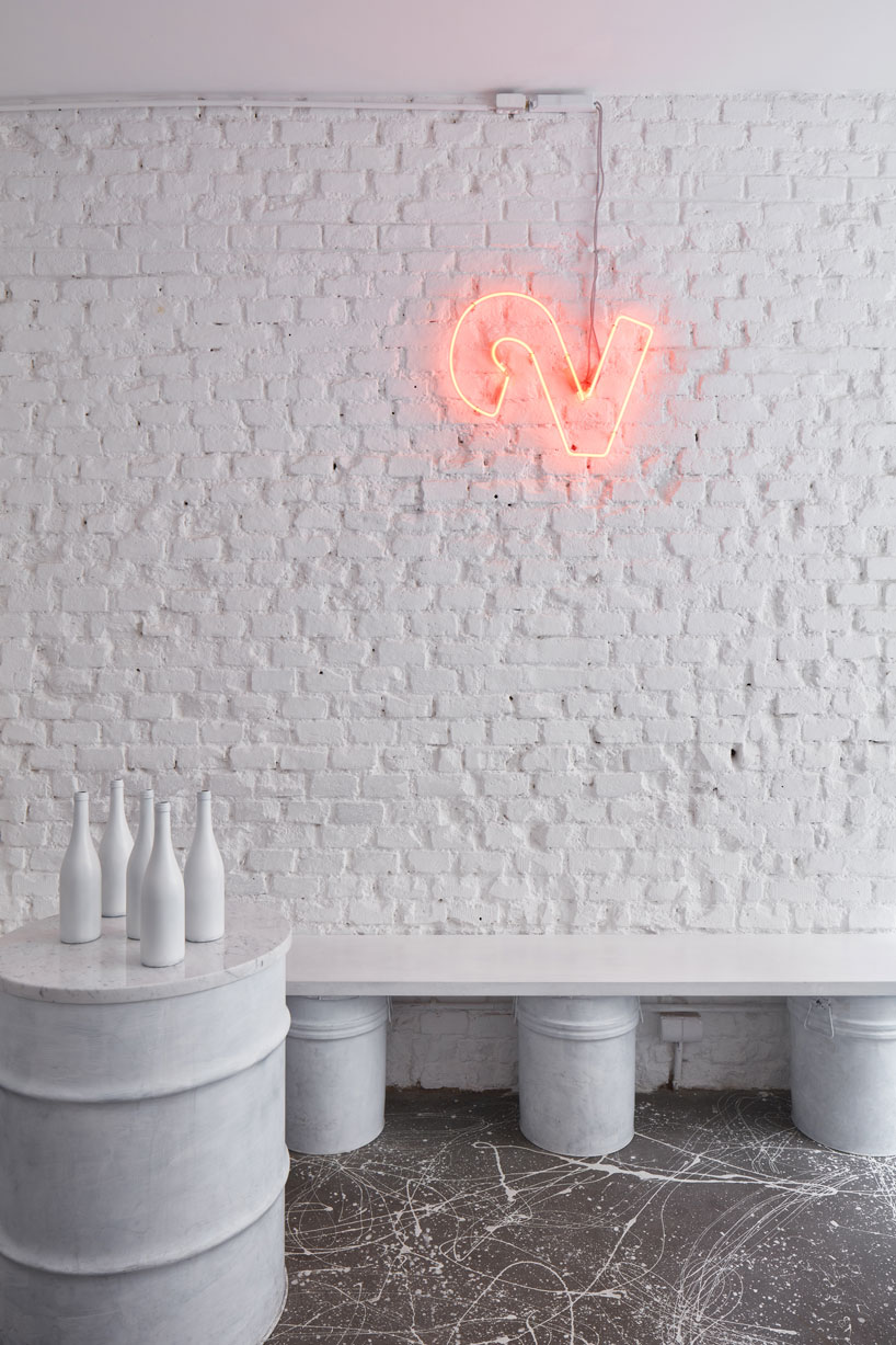 painted entirely white, this prague wine bar recalls a vintage artist studio