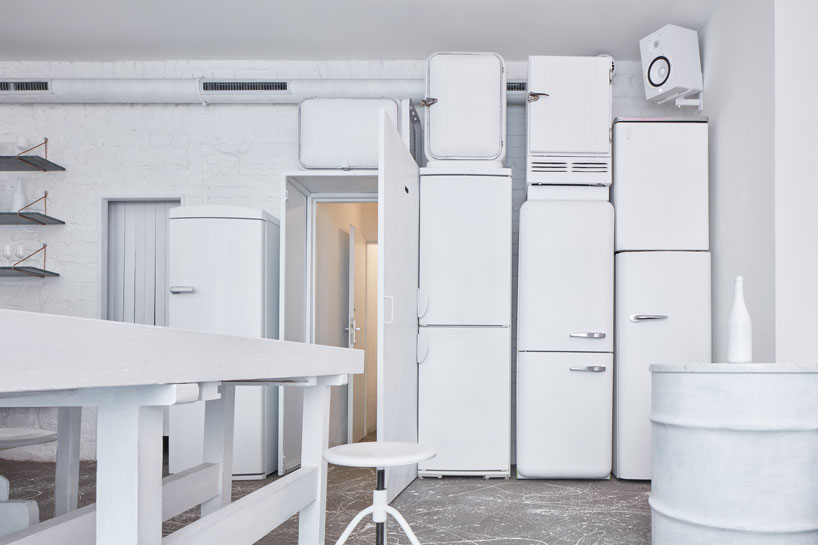 painted entirely white, this prague wine bar recalls a vintage artist studio