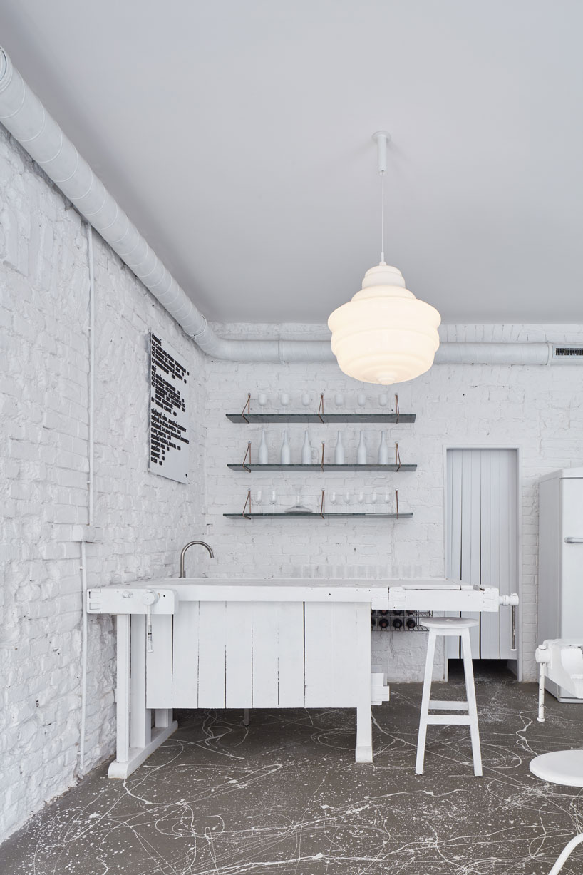 painted entirely white, this prague wine bar recalls a vintage artist studio