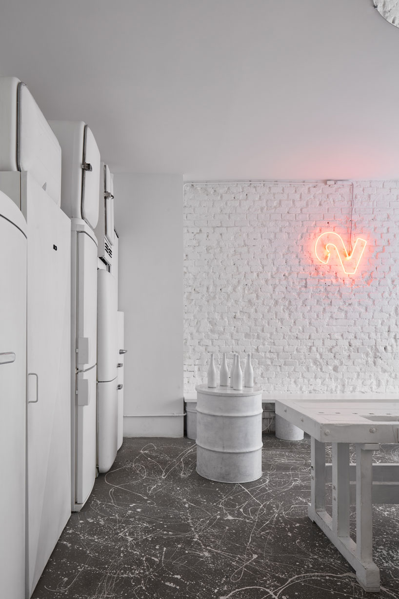 painted entirely white, this prague wine bar recalls a vintage artist studio