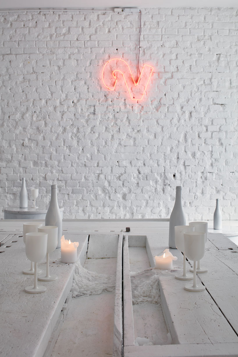 painted entirely white, this prague wine bar recalls a vintage artist studio
