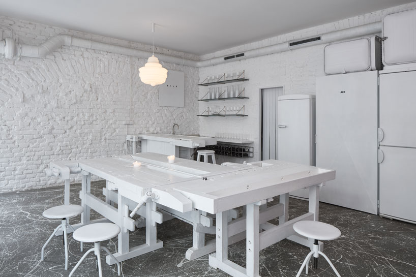 painted entirely white, this prague wine bar recalls a vintage artist studio