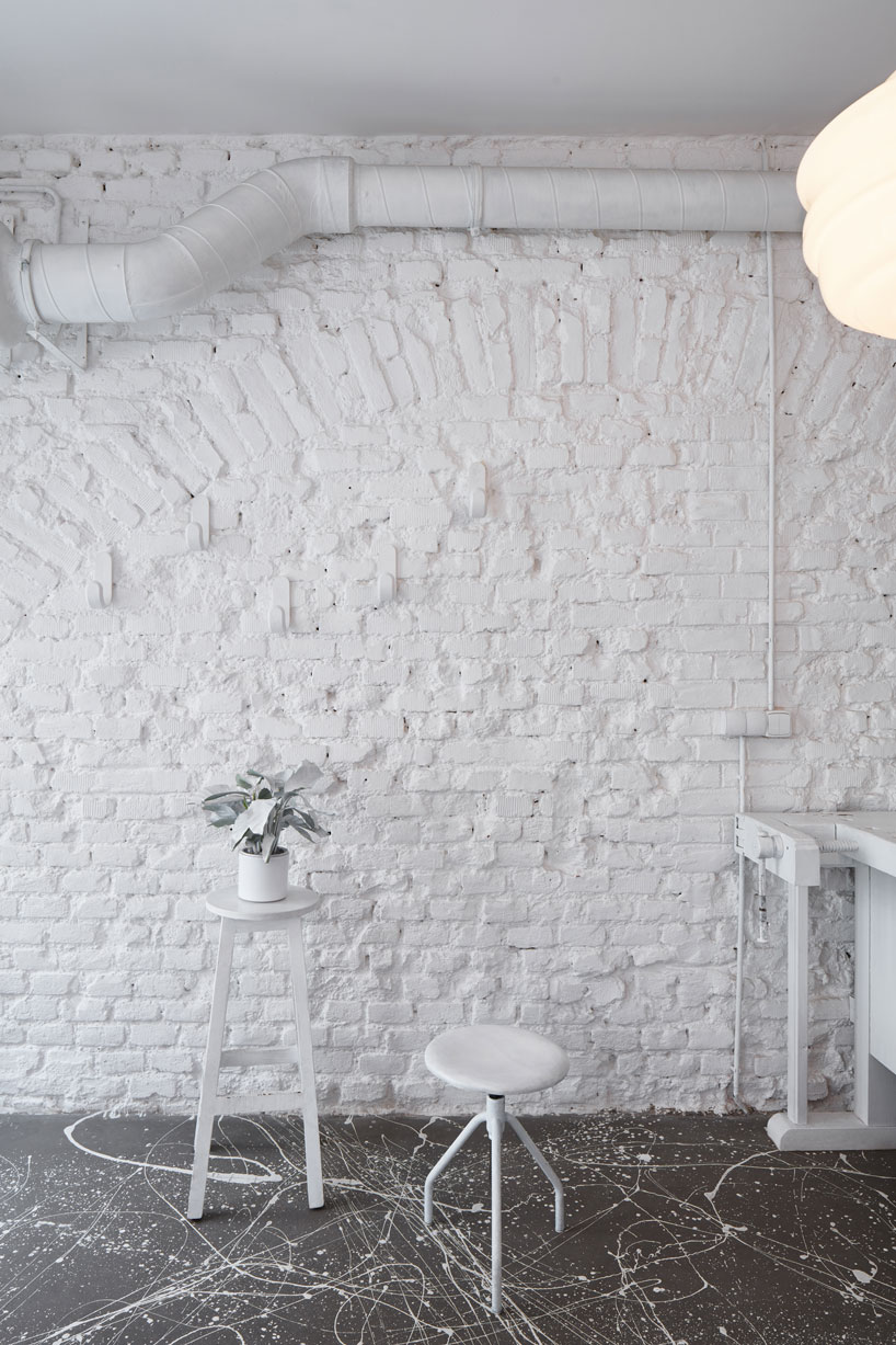 painted entirely white, this prague wine bar recalls a vintage artist studio