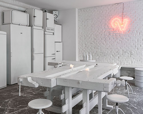 painted entirely white, this prague wine bar recalls a vintage artist studio