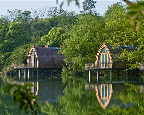 idyllic timber boat rooms are designed to 'float' on the fuchun river in china