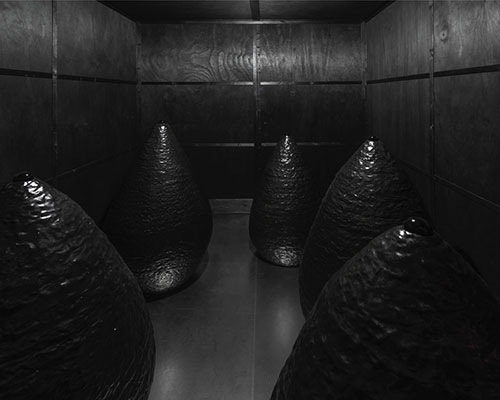 artist turns detroit apartment into a haunting domestic space seemingly raged by fire