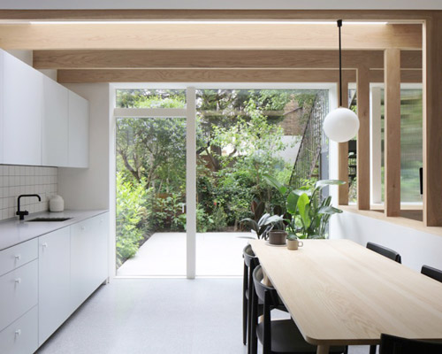 oak posts connect spaces in an english maisonette by architecture for london