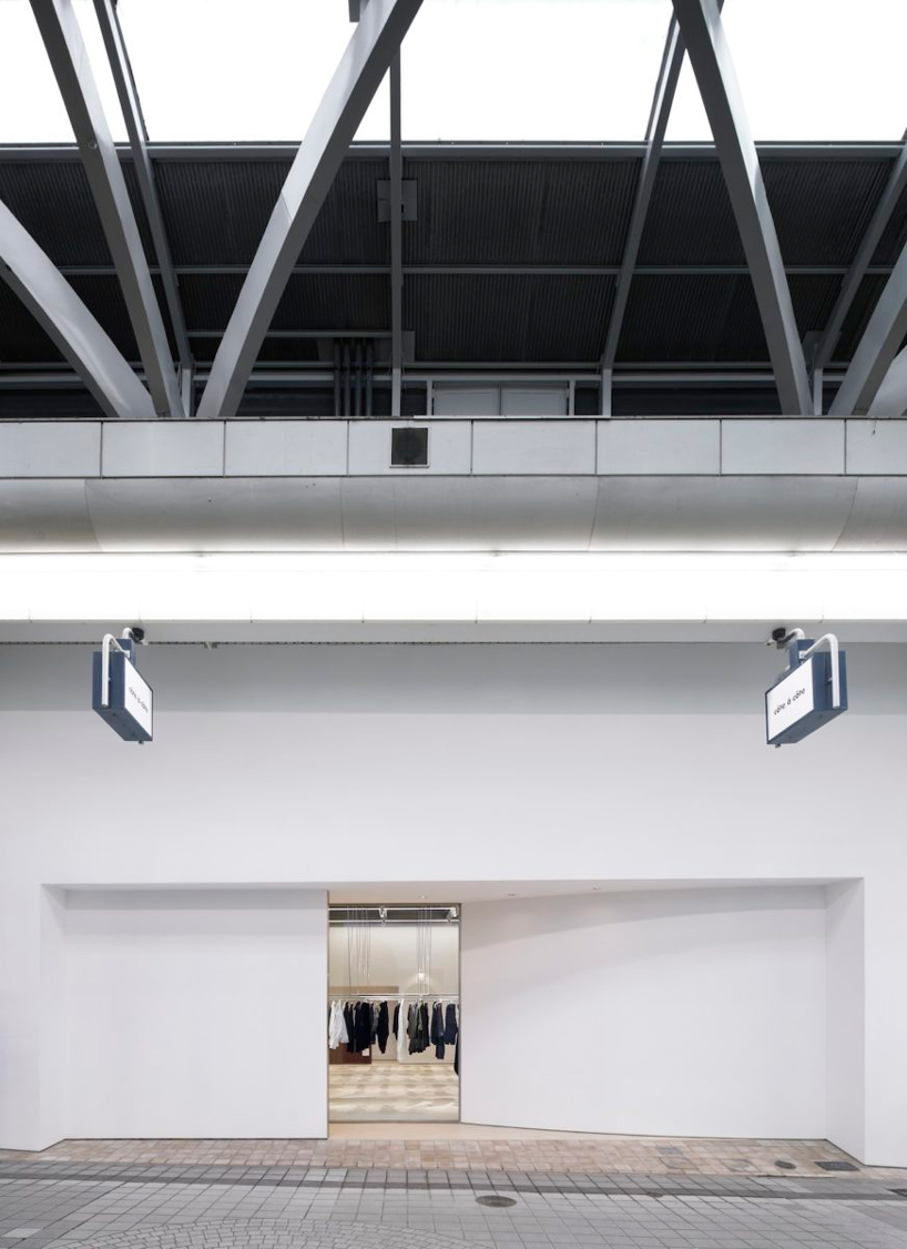 CASE-REAL suspends clothes on V-shaped metal racks at the côte à côte boutique