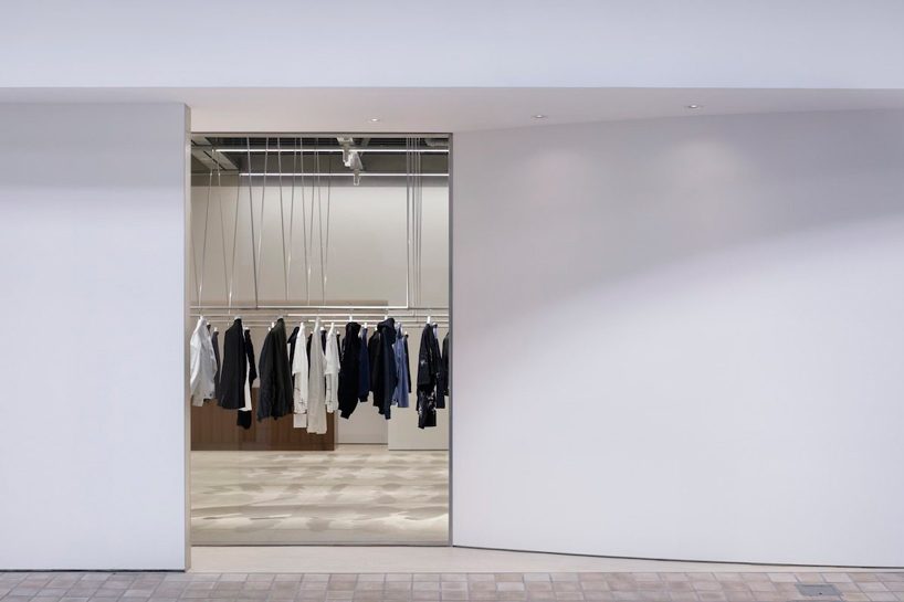 CASE-REAL suspends clothes on V-shaped metal racks at the côte à côte boutique